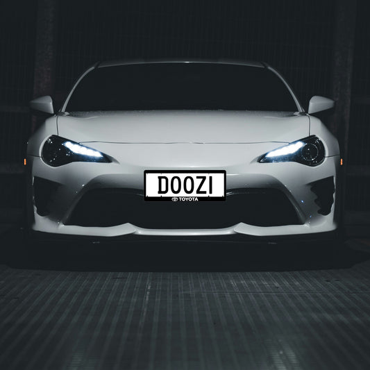 Automotive branded number plate surrounds